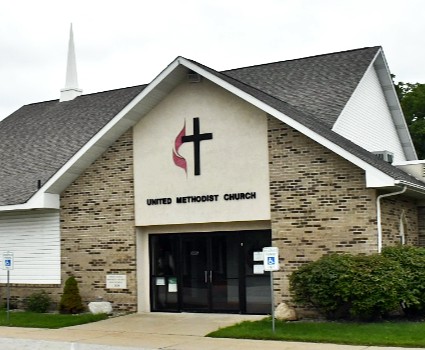 Picture of the First United Methodist Church of New Lothrop in color with steeple and a large logo above the entrance to the front doors.