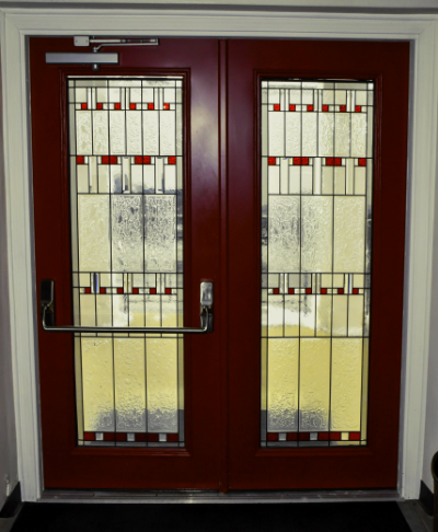 front door of a church with stained glass